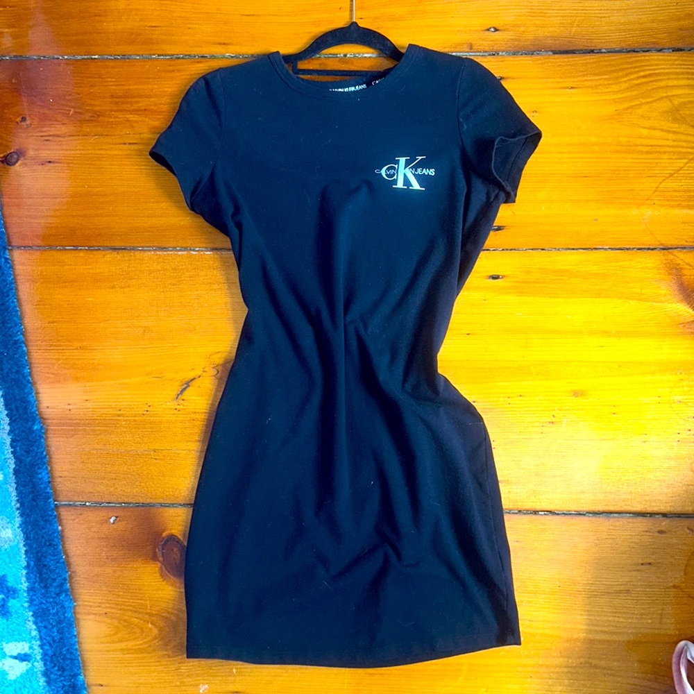 Size small black Calvin Klein dress with emblem on it.